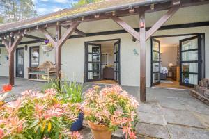 a porch of a house with flowers and plants at 1 Bed in Mumbles oc-hh631 in Oystermouth