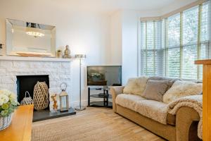 a living room with a couch and a fireplace at 6 Bed in Pwllheli oc-argrai in Abersoch