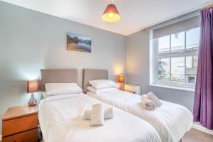 two beds in a bedroom with a window at 2 Bed in Kendal oc-gl097 in Kendal