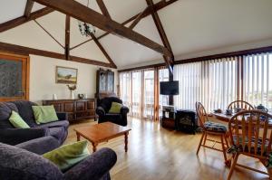a living room with couches and a table at 2 Bed in Welshpool oc-wab256 in Berriew