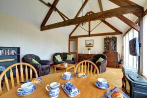a living room with a wooden table and chairs at 2 Bed in Welshpool oc-wab256 in Berriew