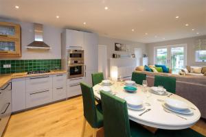 a kitchen and living room with a table and chairs at 4 Bed in Pwllheli oc-lluest in Abersoch