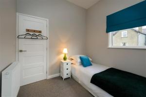 a small bedroom with a bed and a window at 4 Bed in Pwllheli oc-lluest in Abersoch