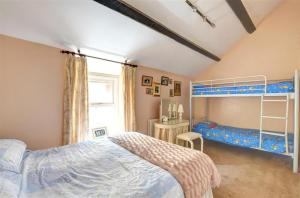 a bedroom with two beds and a bunk bed at 2 Bed in Caernarfon oc-wag359 in Caernarfon