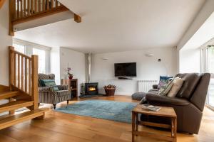 a living room with a couch and a fireplace at 1 Bed in Corwen oc-fl010 in Derwen