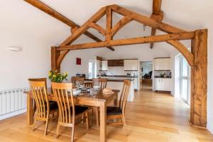 a kitchen and dining room with a wooden table and chairs at 1 Bed in Corwen oc-fl010 in Derwen