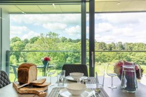 a dining room with a table and a large window at 1 Bed in Buxted oc-t32799 in Buxted