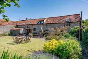 an old stone house with a garden in front of it at 3 Bed in Binham oc-2235 in Binham