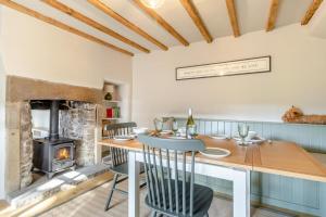 a dining room with a table and a fireplace at 3 Bed in Calver oc-h33087 in Curbar