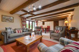 a living room with couches and a table at 3 Bed in Binham oc-2235 in Binham