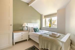 a white bedroom with a bed and a window at 3 Bed in Calver oc-h33087 in Curbar