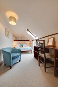 a bedroom with a bed and a chair and a desk at 3 Bed in Binham oc-2235 in Binham