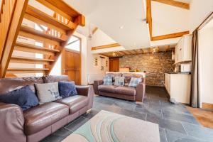 a living room with two couches and a kitchen at 3 Bed in Gower oc-hh407 in Llanmadoc
