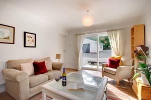 a living room with a couch and a table at 4 Bed in Swansea oc-hh642 in Oystermouth