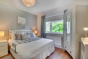 a bedroom with a white bed and a window at 4 Bed in Swansea oc-hh642 in Oystermouth