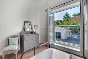 a bedroom with a large window and a dresser at 4 Bed in Swansea oc-hh642 in Oystermouth