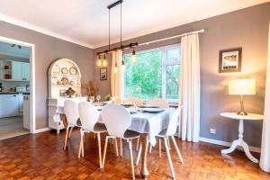 a dining room with a white table and chairs at 4 Bed in Swansea oc-hh642 in Oystermouth