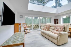a living room with a couch and a flat screen tv at 4 Bed in Harmans Cross oc-wy278 in Corfe Castle