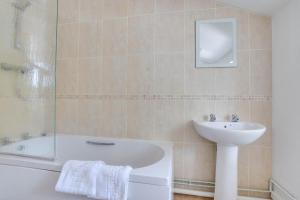 a bathroom with a tub and a sink and a bath tub at 4 Bed in Harmans Cross oc-wy278 in Corfe Castle +18 photos