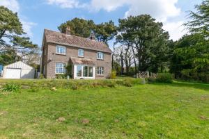 an exterior view of a house with a yard at 4 Bed in Harmans Cross oc-wy278 in Corfe Castle
