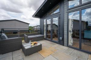 a patio with wicker chairs and a table at 3 Bed in Burnham Market oc-2334 in Burnham Market