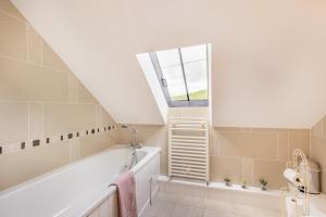 a bathroom with a bath tub and a window at 2 Bed in Bala oc-82768 in Llandderfel +30 photos