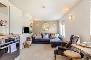 a living room with a blue couch and a table at 2 Bed in St. Ives oc-p00568 in St Ives