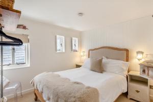 a white bedroom with a bed with white sheets and pillows at 2 Bed in St. Ives oc-p00568 in St Ives