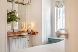 a bathroom with a mirror and a sink and a window at 2 Bed in St. Ives oc-p00568 in St Ives +19 photos