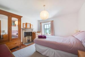a bedroom with a large bed and a fireplace at 3 Bed in Bakewell oc-dckno in Youlgreave