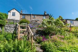 a house on top of a hill with flowers at 3 Bed in Bakewell oc-dckno in Youlgreave