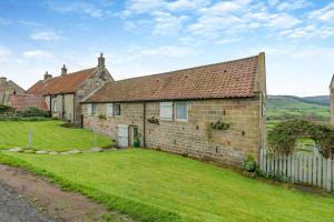 an old brick house with a grass yard in front of it at 2 Bed in Glaisdale oc-wa306 in Glaisdale