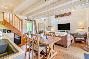 a kitchen and living room with a wooden table and chairs at 2 Bed in Glaisdale oc-wa306 in Glaisdale