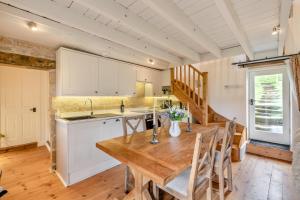 a kitchen and dining room with a wooden table and chairs at 2 Bed in Glaisdale oc-wa306 in Glaisdale