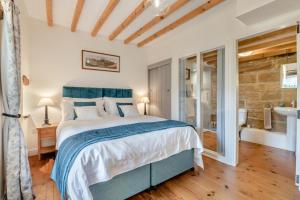 a bedroom with a large bed and a stone wall at 2 Bed in Glaisdale oc-wa306 in Glaisdale