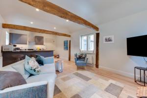 a living room with a white couch and a flat screen tv at 1 Bed in Middleton oc-stbc in Middleton