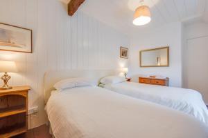 two beds in a room with white walls at 3 Bed in Dolgellau oc-wah569 in Llanfachreth