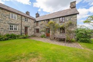 an exterior view of a stone house with a yard at 3 Bed in Dolgellau oc-wah569 in Llanfachreth