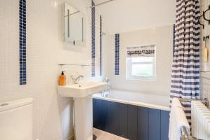 a white bathroom with a sink and a bath tub at 2 Bed in Snape oc-wico in Snape +28 photos