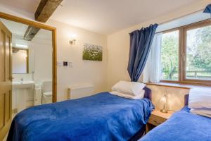 a bedroom with two beds and a mirror at 2 Bed in Smallburgh oc-h33733 in Dilham +21 photos