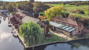 an aerial view of a house on a river at 2 Bed in Smallburgh oc-h33733 in Dilham
