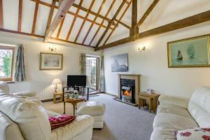 a living room with two white couches and a fireplace at 2 Bed in Smallburgh oc-h33733 in Dilham