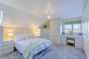 a white bedroom with a bed and a desk at 2 Bed in Dunnington oc-s34137 in Dunnington