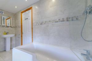 a bathroom with a white tub and a sink at 2 Bed in Dunnington oc-s34137 in Dunnington +15 photos