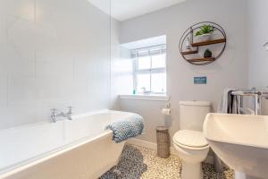 a bathroom with a tub and a toilet and a sink at 2 Bed in Big Sand oc-d33686 in Big Sand +29 photos