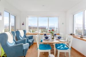 a dining room with a table and chairs and windows at 2 Bed in Big Sand oc-d33686 in Big Sand