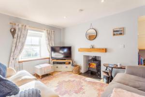 a living room with a couch and a tv and a fireplace at 2 Bed in Big Sand oc-d33686 in Big Sand