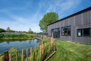 a house with a pond in front of it at 5 Bed in Briston oc-2305 in Briston