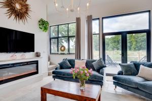 a living room with blue couches and a fireplace at 5 Bed in Briston oc-2305 in Briston