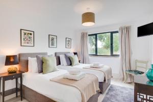 a bedroom with two beds and a window at 5 Bed in Briston oc-2305 in Briston